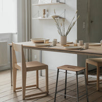 Light wood dining table with minimalist design, featuring neutral tones and subtle natural textures.