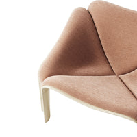 Soft pink upholstery with a subtle texture, featuring a modern, curved design and light wood accents.