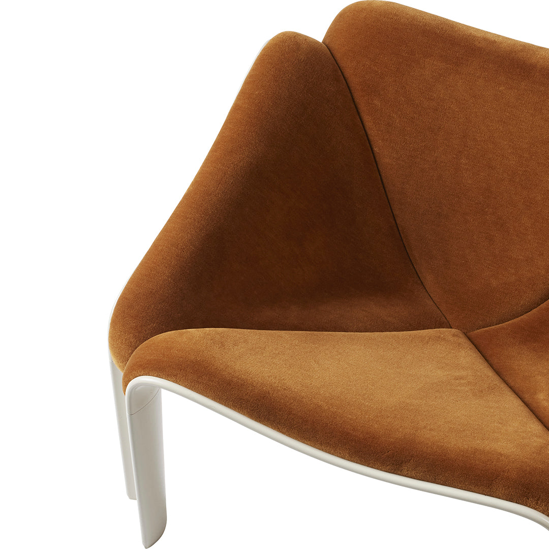 Brown suede chair with a modern design and smooth white legs, featuring clean lines and a minimalist aesthetic.
