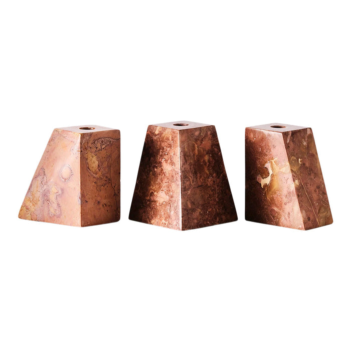 Set of three angular candle holders in warm brown hues with subtle veining and polished finishes.