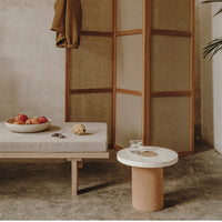 "Neutral tones with a textured, cork base and white circular top. Earthy colors complement minimalist decor."