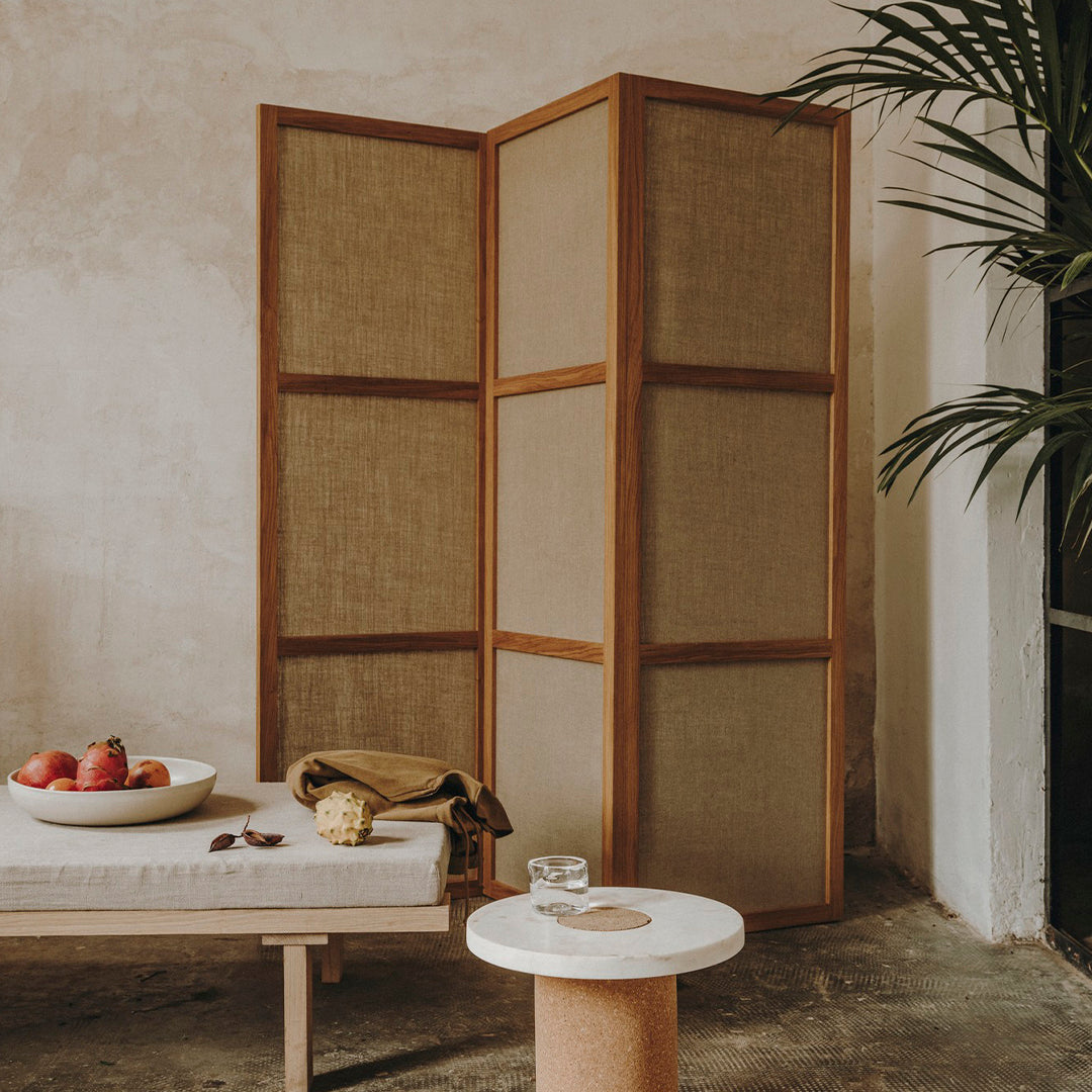 Natural wood and neutral woven fabric screen with earthy tones, creating a warm, calming aesthetic.