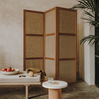 Natural wood and neutral woven fabric screen with earthy tones, creating a warm, calming aesthetic.