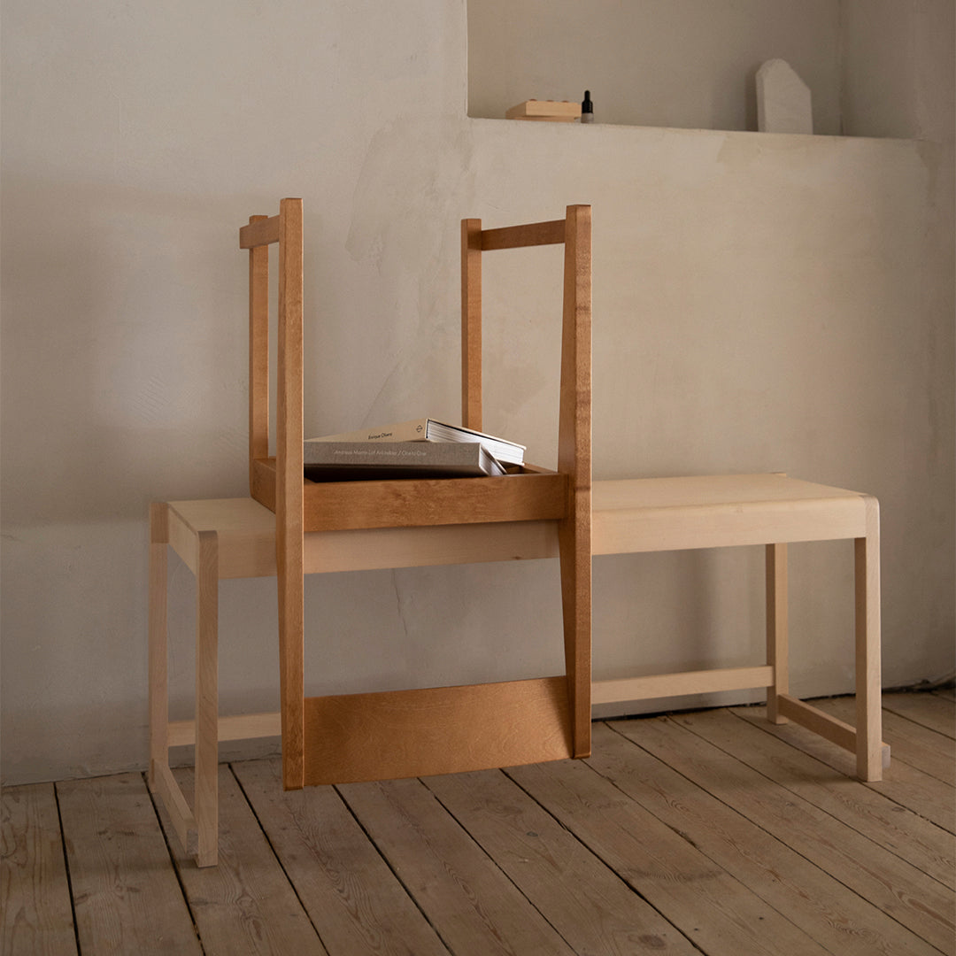 Light wood chair and table with a minimalist design, featuring natural grain patterns and a warm, neutral palette.