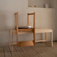 Light wood chair and table with a minimalist design, featuring natural grain patterns and a warm, neutral palette.