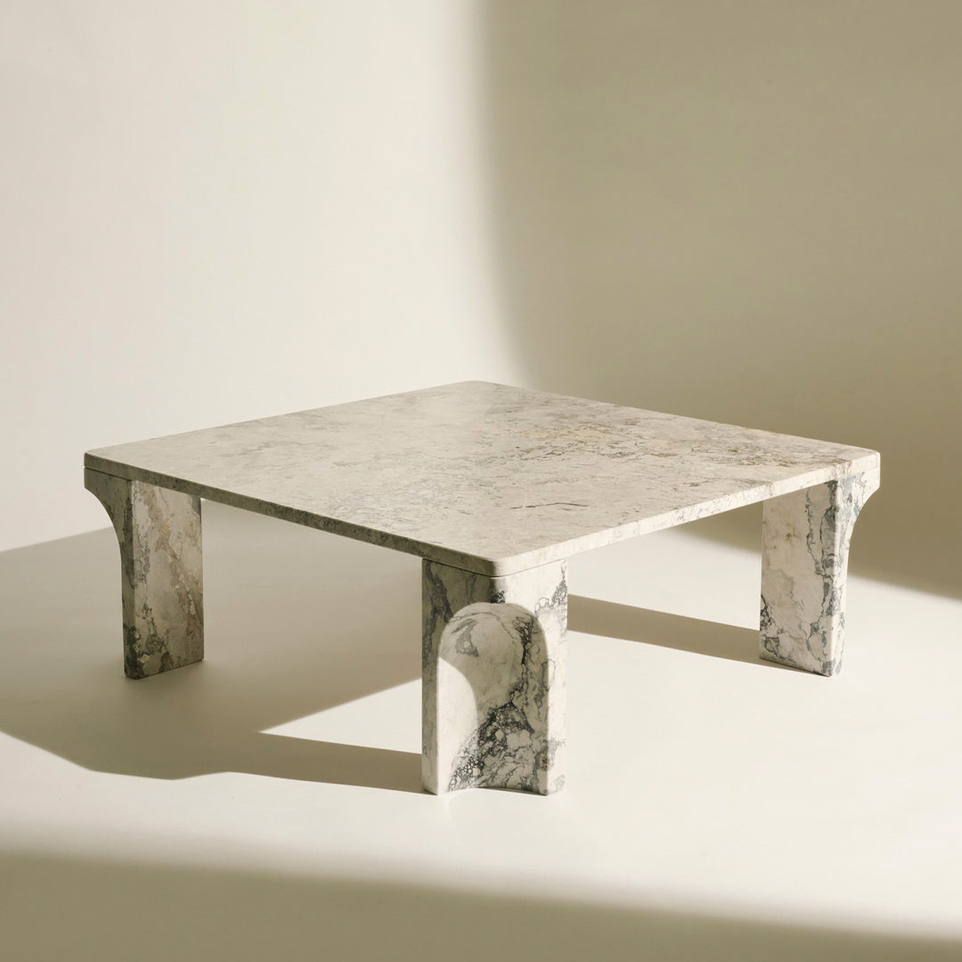 Gray marble coffee table with a sleek, minimalist design and distinctive veining patterns on the surface and legs.