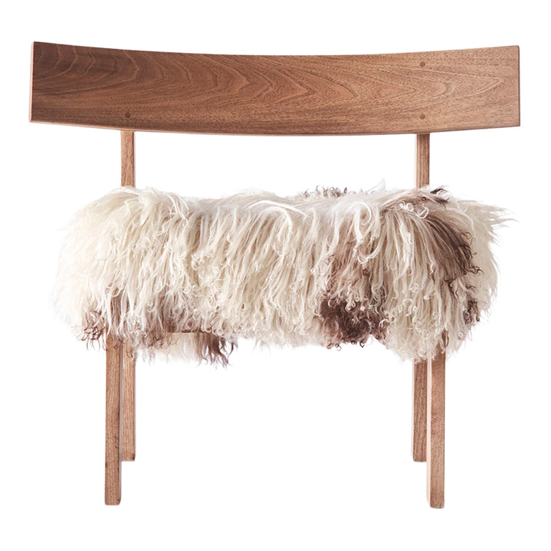 Natural wood chair with white and brown shaggy fur seat, featuring a soft, textured surface and organic patterns.