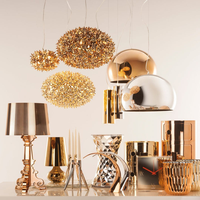 Gold and silver decorative lighting and accessories with intricate patterns for a luxurious home ambiance.