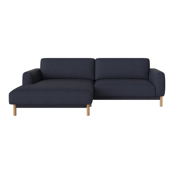 Navy blue sectional sofa with a modern design and light wood legs, featuring a smooth, textured fabric.