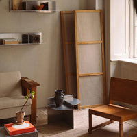 "Neutral tones with warm wood textures and minimalist patterns in a cozy living space."