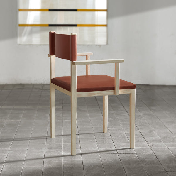 "Modern chair with a warm reddish-brown seat and backrest, featuring a light wood frame."