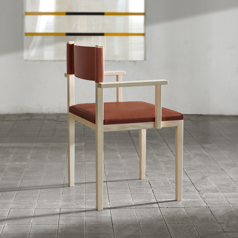 "Modern chair with a warm reddish-brown seat and backrest, featuring a light wood frame."