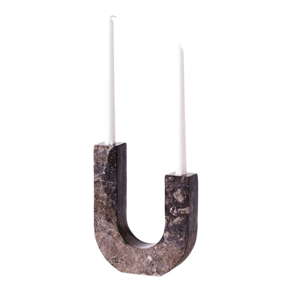 Stylish U-shaped candle holder in dark gray with a textured surface, topped with two white candles. Perfect for modern décor.