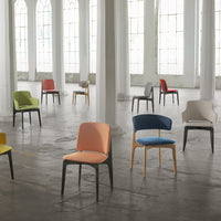 Colorful chairs in various shades: orange, blue, green, red, and beige with simple, modern designs.