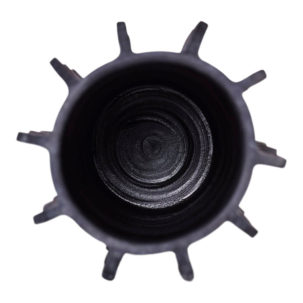 Black cylindrical container with spiky exterior pattern and smooth inner surface, showcasing a modern, sleek design.