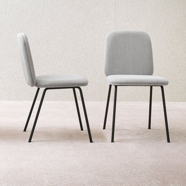Two modern chairs in light gray upholstery with black metal legs, featuring a simple and minimalist design.
