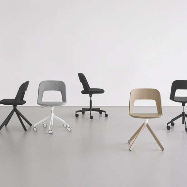 Five modern chairs in black, gray, and beige with sleek, minimalist designs on a smooth, gray floor.