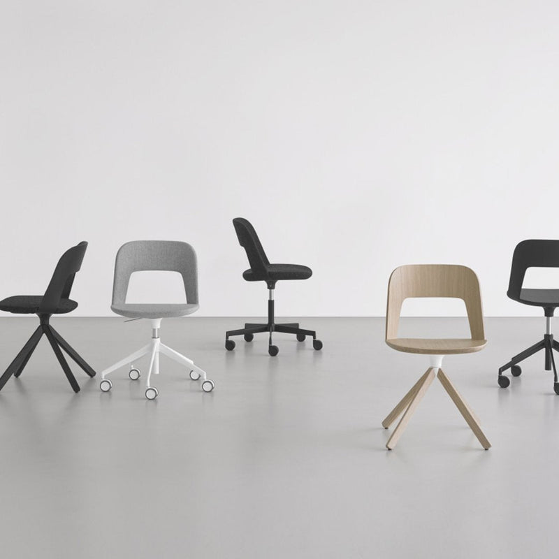 Five modern chairs in black, gray, and beige with sleek, minimalist designs on a smooth, gray floor.