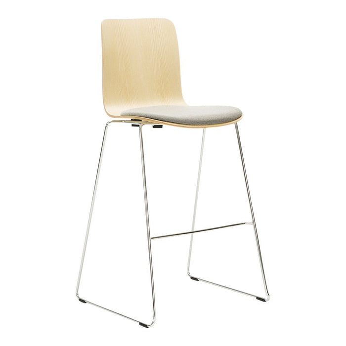 Modern wooden bar stool in light natural wood with a sleek white cushion and minimalist chrome legs.