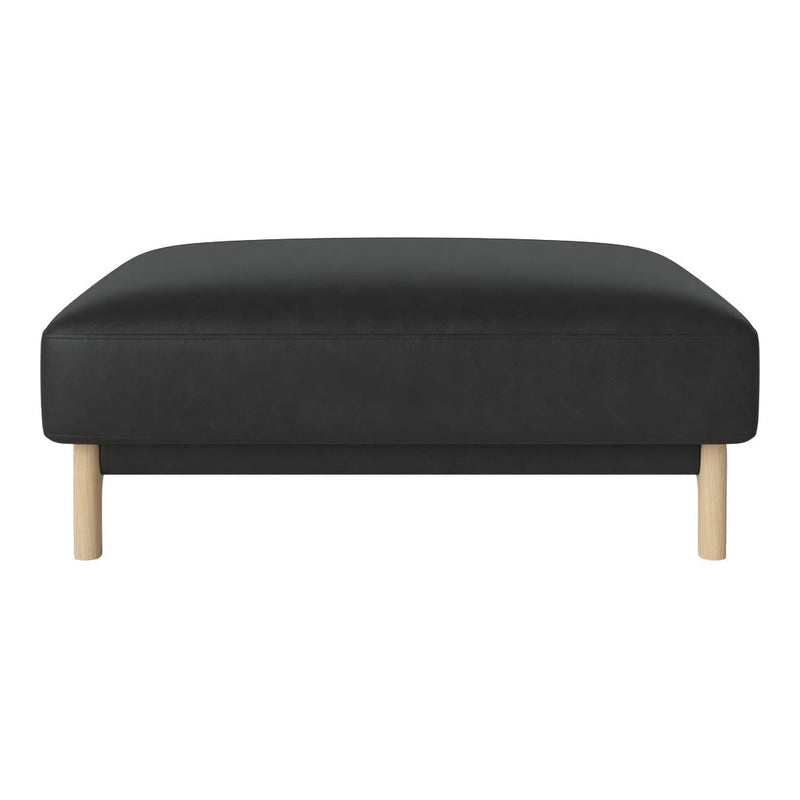 Black upholstered ottoman with natural wooden legs, featuring a sleek, minimalist design.