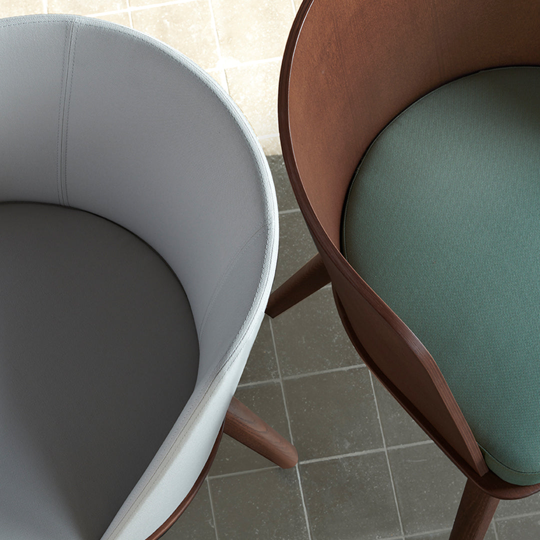 Gray and green upholstered chairs with smooth, modern patterns and natural wooden legs. Stylish and contemporary design.