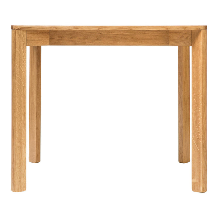 Natural wood finish dining table with clean lines and a minimalist design, showcasing warm beige tones.