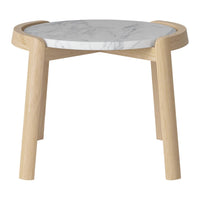 Light wooden legs support a round marble tabletop with subtle gray veining, creating a modern, elegant look.