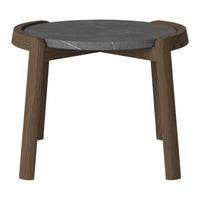 Modern round side table with a dark marble top and a warm brown wooden base. Sleek and minimalist design.