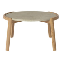 Light wooden legs support a round, textured stone tabletop in neutral tones, perfect for modern decor.