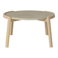Modern round coffee table with a gray stone top and light wood legs, featuring a smooth, minimalist design.