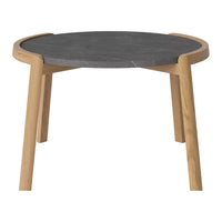 Round table with a gray stone top and natural wood legs, featuring a sleek, minimalist design.