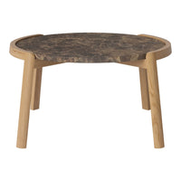 Natural wood legs support a round tabletop with a dark brown, marbled pattern, adding elegant contrast to any space.