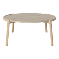 Light wood round coffee table with a smooth grain finish and natural beige tones.