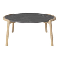 Round black marble coffee table with natural wood legs, featuring a simple and modern design.