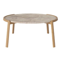 Round coffee table with a light wood base and a textured beige stone top, featuring a minimalist design.