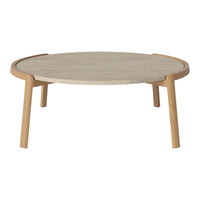 Round coffee table with a light wood finish and a textured cream tabletop, featuring minimalist design and natural colors.
