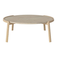 Round coffee table in light wood finish with a smooth, natural grain pattern, featuring minimalist Scandinavian design.