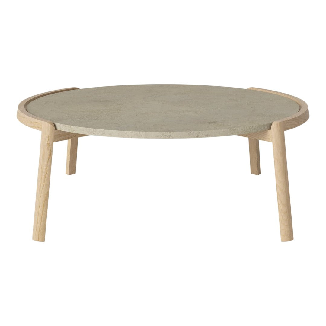 Round coffee table with a smooth gray top and light wooden legs. Minimalist design with a natural finish.