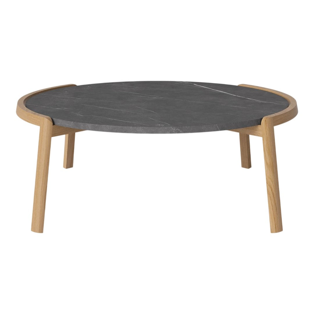 Round coffee table with a sleek dark gray top and natural wood legs, showcasing a minimalist design.
