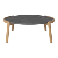 Round coffee table with a sleek dark gray top and natural wood legs, showcasing a minimalist design.