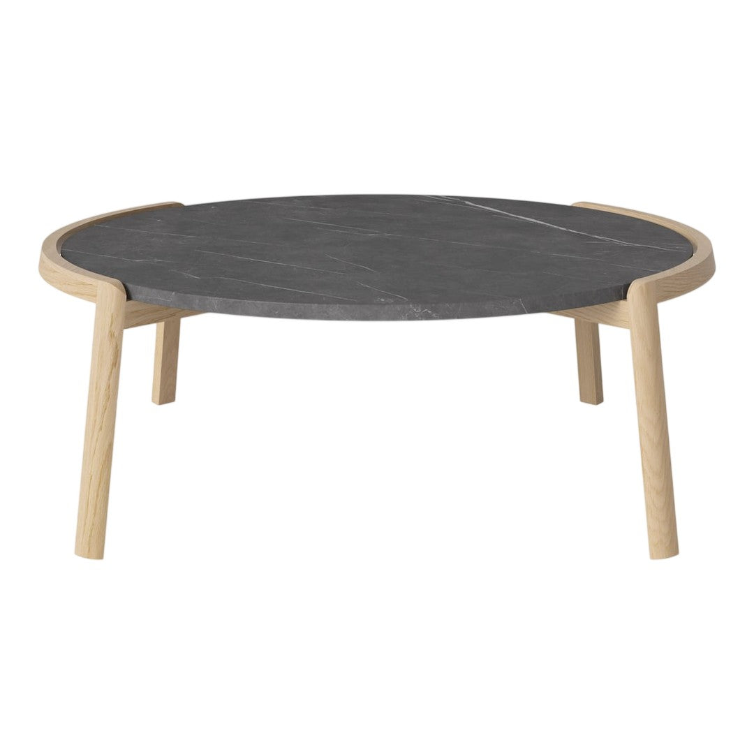 Round coffee table featuring a sleek dark gray surface with natural wood legs. Minimalist design with clean lines.