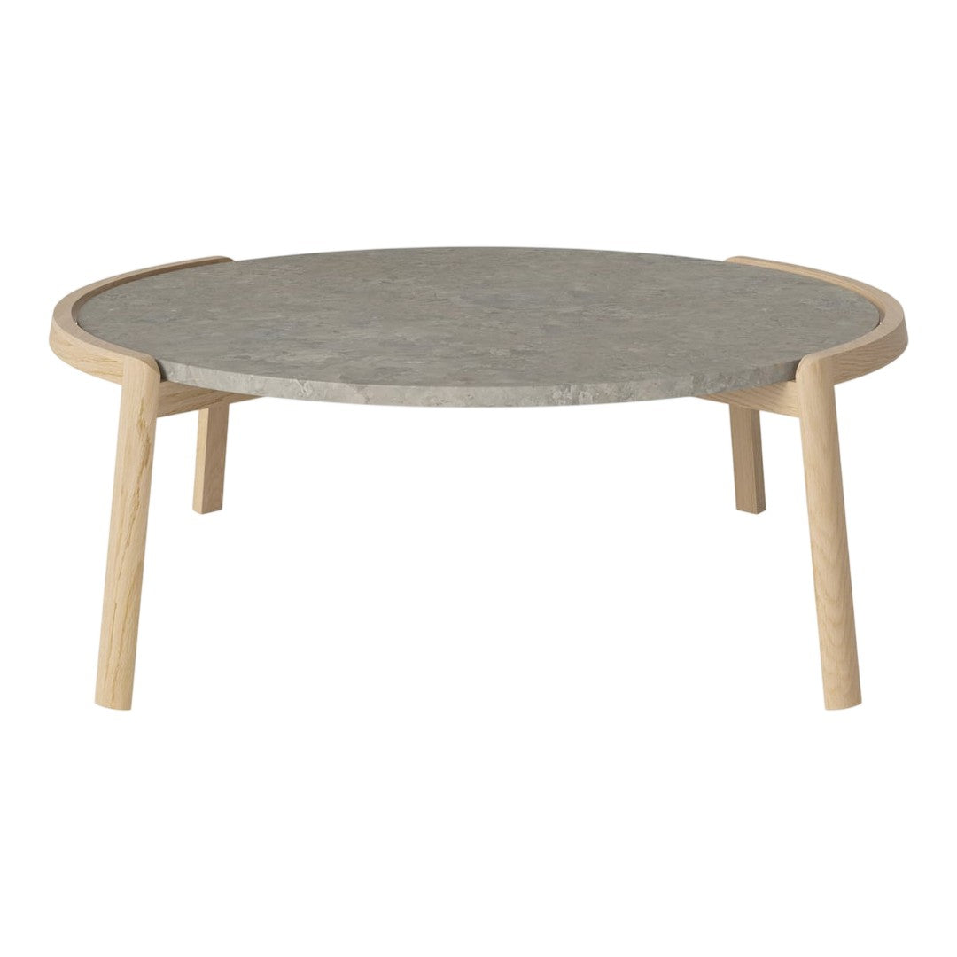 Round coffee table with a smooth gray stone top and natural wood legs, featuring a minimalist design.