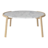 Round coffee table featuring a white marble top with gray veining and natural wood legs, adding modern elegance.