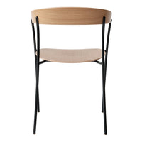 Modern chair featuring a natural wood finish with curved backrest and sleek black metal legs. Elegant and minimal design.