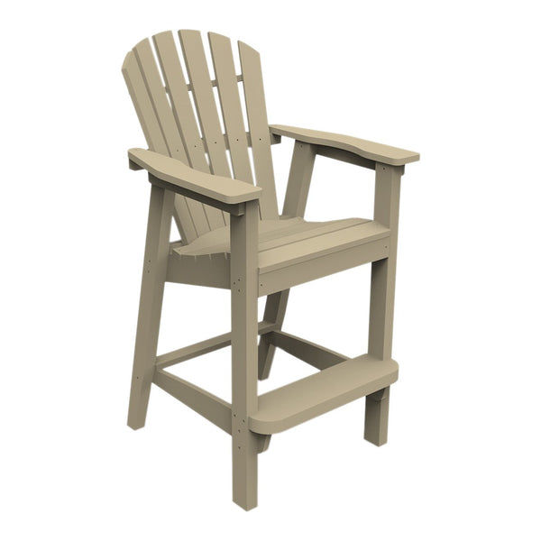 Tan Adirondack chair with a slatted back and arms, featuring a simple, coastal-inspired design.