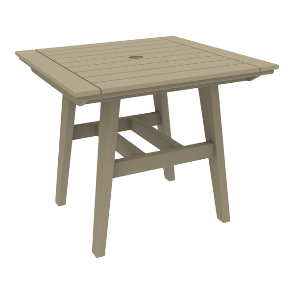 Square outdoor table in taupe with slatted surface and a center hole for an umbrella. Ideal for patio or garden use.