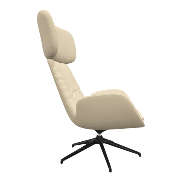 Cream-colored lounge chair with a sleek design and black base, featuring subtle tufted patterns.