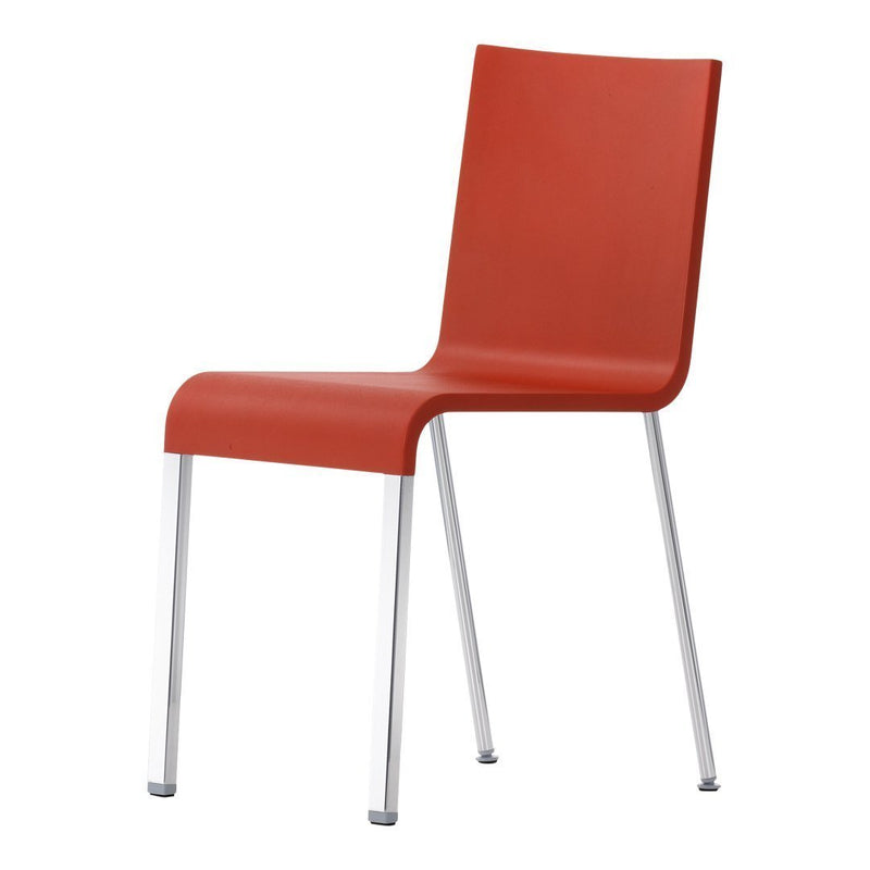 Red plastic chair with a sleek, minimalist design and silver metal legs, perfect for modern decor.