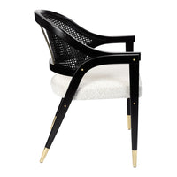 Modern black woven chair with a cream upholstered seat and gold accents on the legs. Elegant and stylish design.
