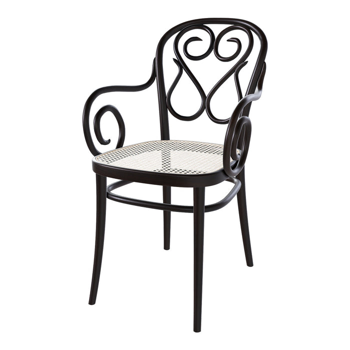 Black wrought iron chair with ornate swirls and a woven cane seat, perfect for elegant decor.
